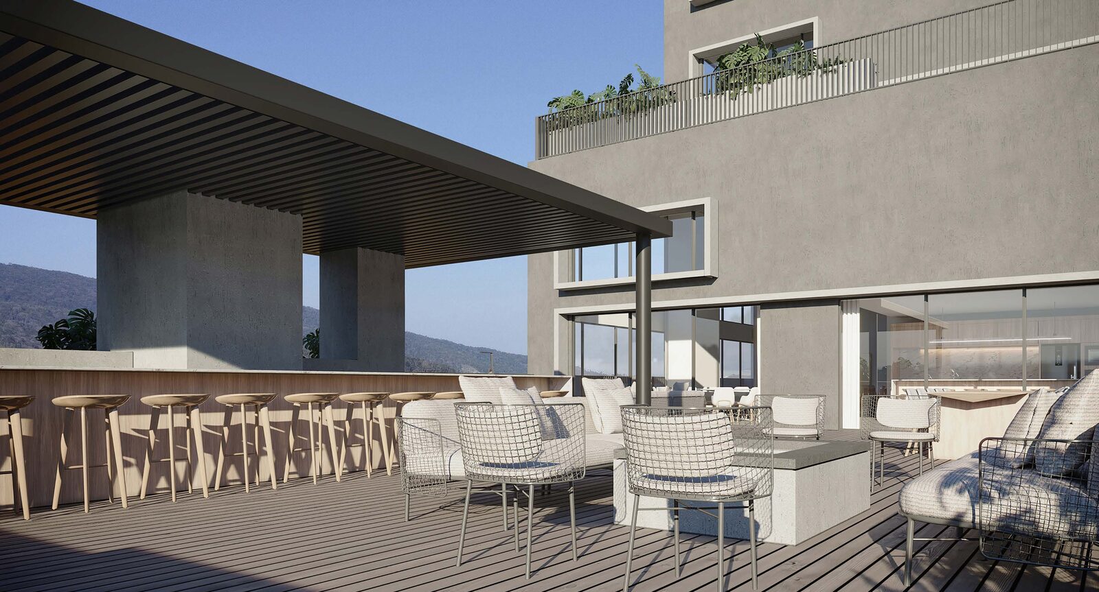 Terraço social coberto com sofás e bar