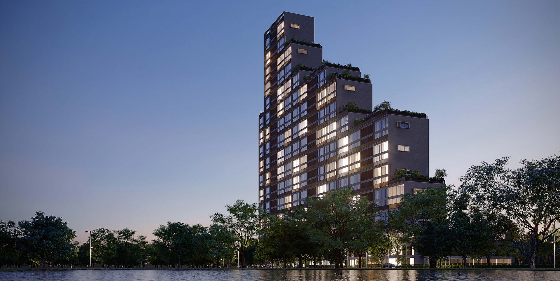 Fachada do edifício Vista Jardins ao entardecer, com iluminação dourada refletida nas janelas